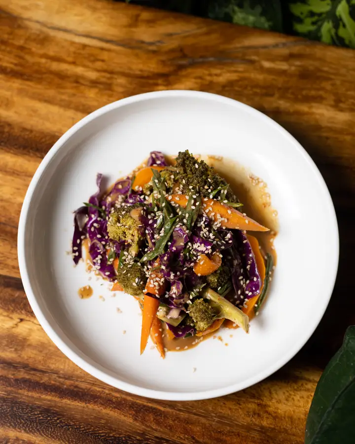 Bowl of fermented vegetables with red cabbage, carrot, sesame and peanut sauce
